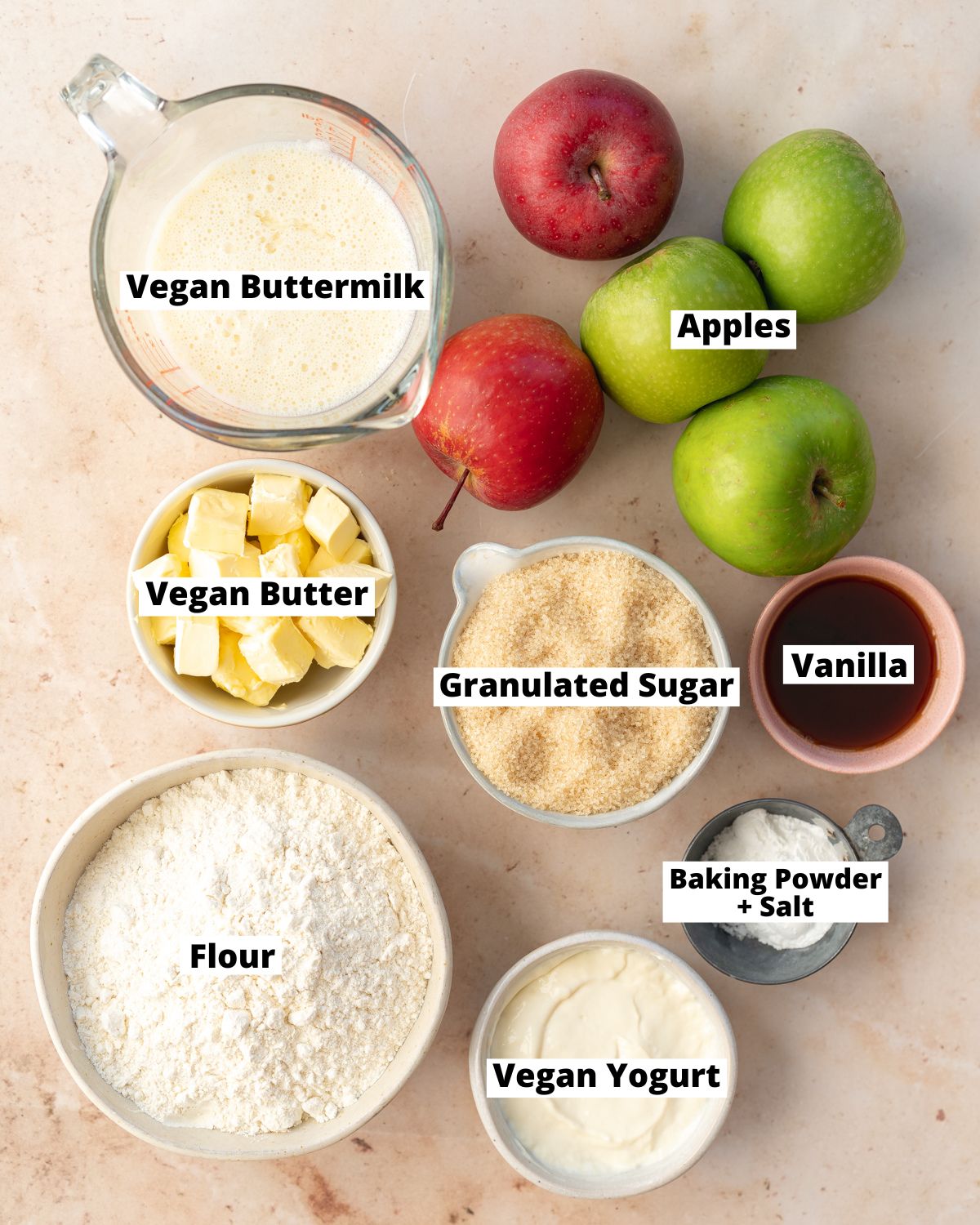 ingredients to make vegan apple cake measured out in bowls.