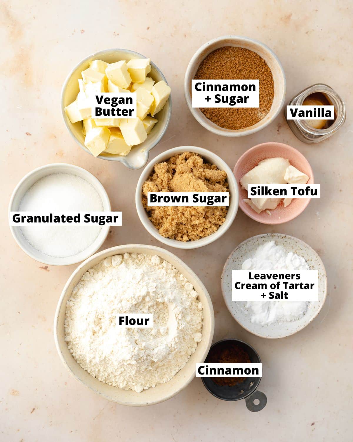 ingredients for snickerdoodle cookies measured out in bowls.