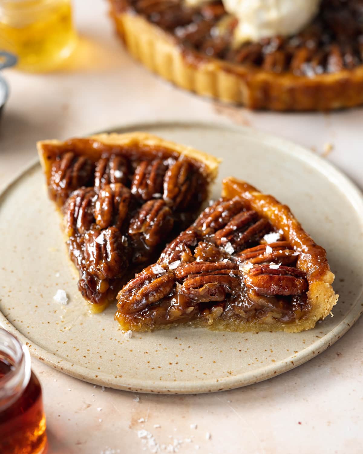 two slices of pecan pie on a ceramic plate.