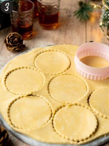 vegan pastry rolled out with round cut out with a cookie cutter.