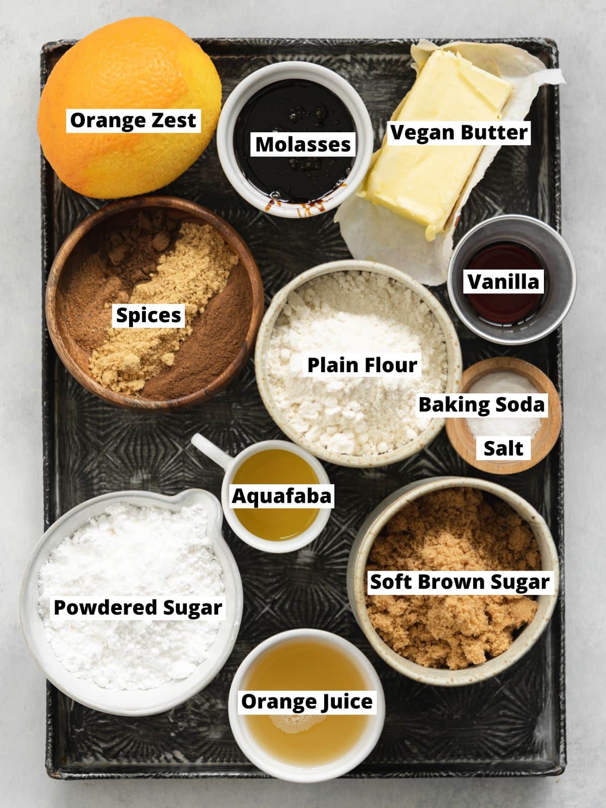 ingredients to make vegan gingerbread men measured out on a vintage tray.