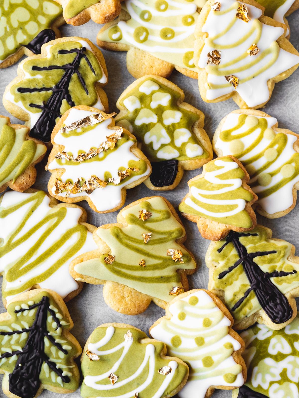 christmas tree cookies on a tray with parchment paper.