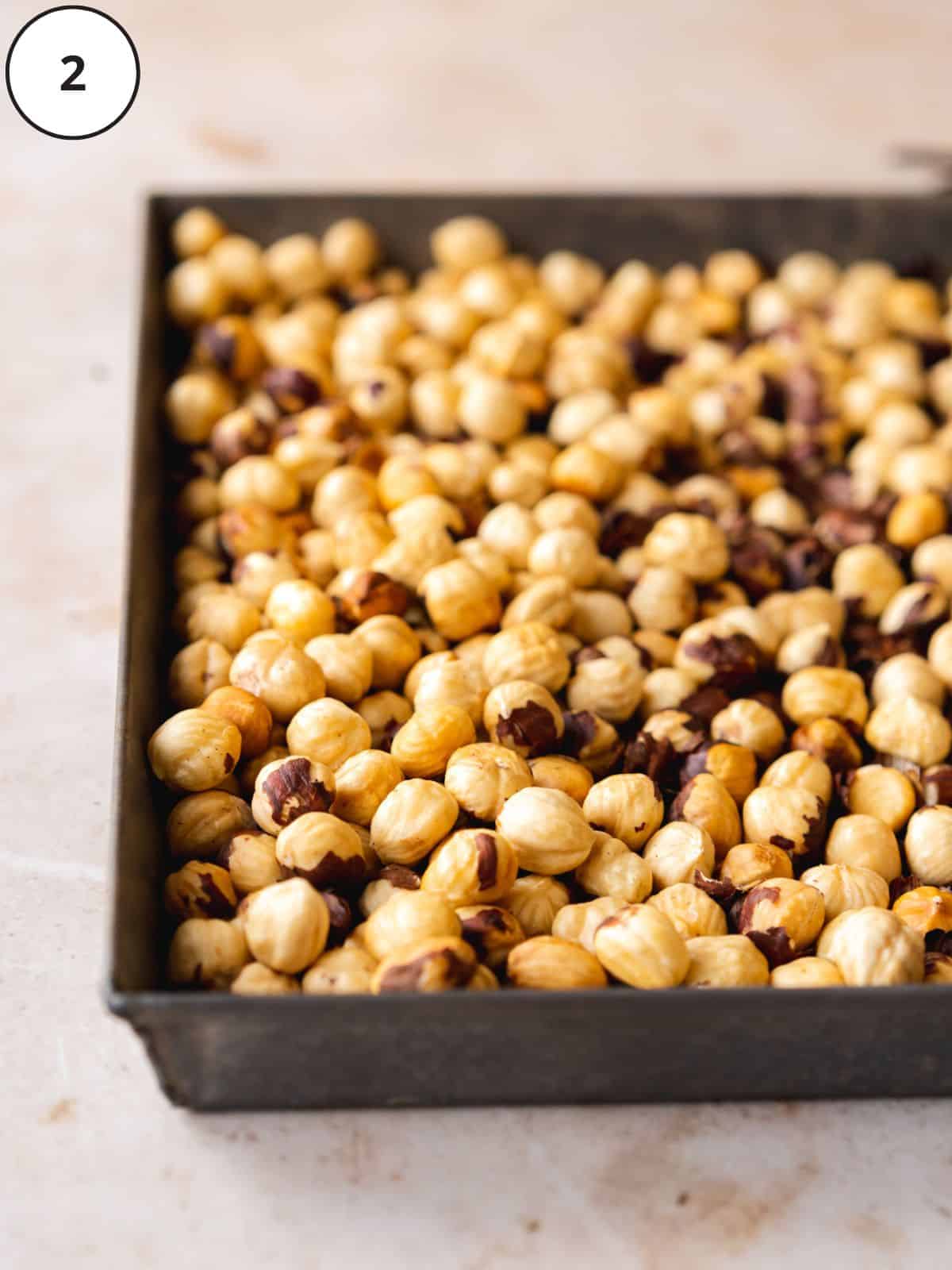 roasted hazelnuts without skins on a baking sheet.