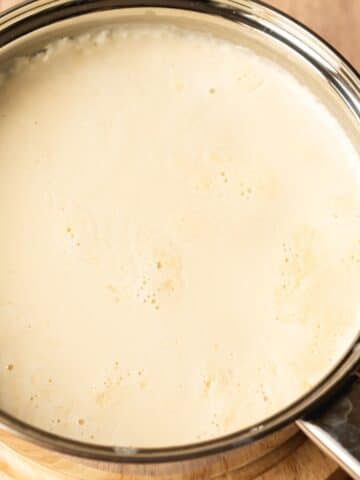 mascarpone in a saucepan with curds separating from the liquids.