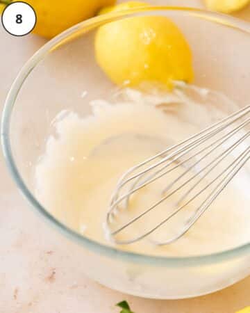 Lemon glaze in a mixing bowl after whisking to smooth perfection.