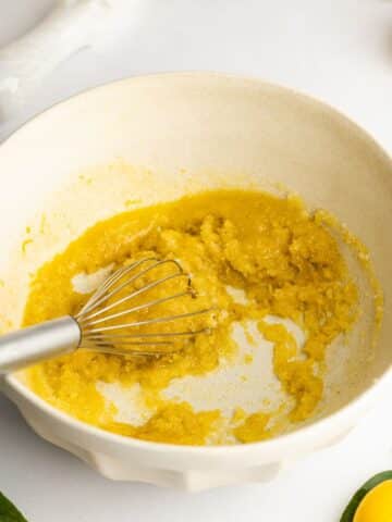 Melted butter added to the sugar mixture - the mix looks dry and thick.