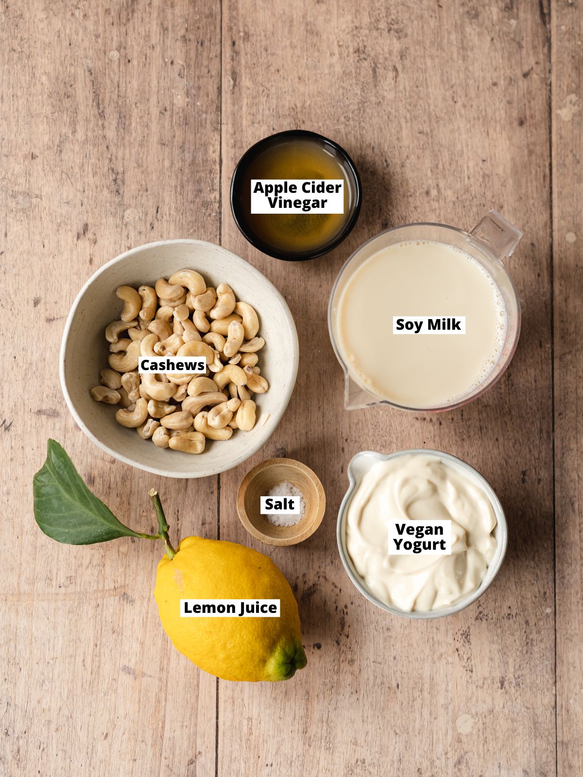 ingredients to make vegan ricotta cheese measured out in bowls on a wooden surface.
