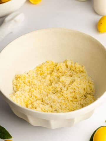 Sugar, lemon zest, and vanilla beans mixed together in a bowl.