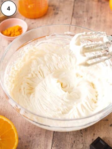 Vegan cream cheese and yogurt whipped together in a mixing bowl.