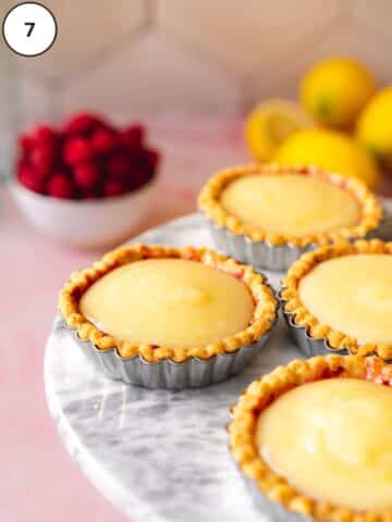 Vegan lemon curd layered into the mini tart shells.