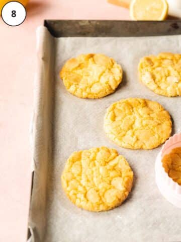 vegan lemon cookies on a baking sheet fresh out of the oven.