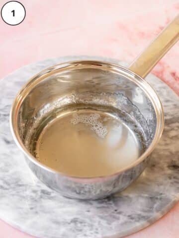 sugar syrup for Italian meringue buttercream in a saucepan.