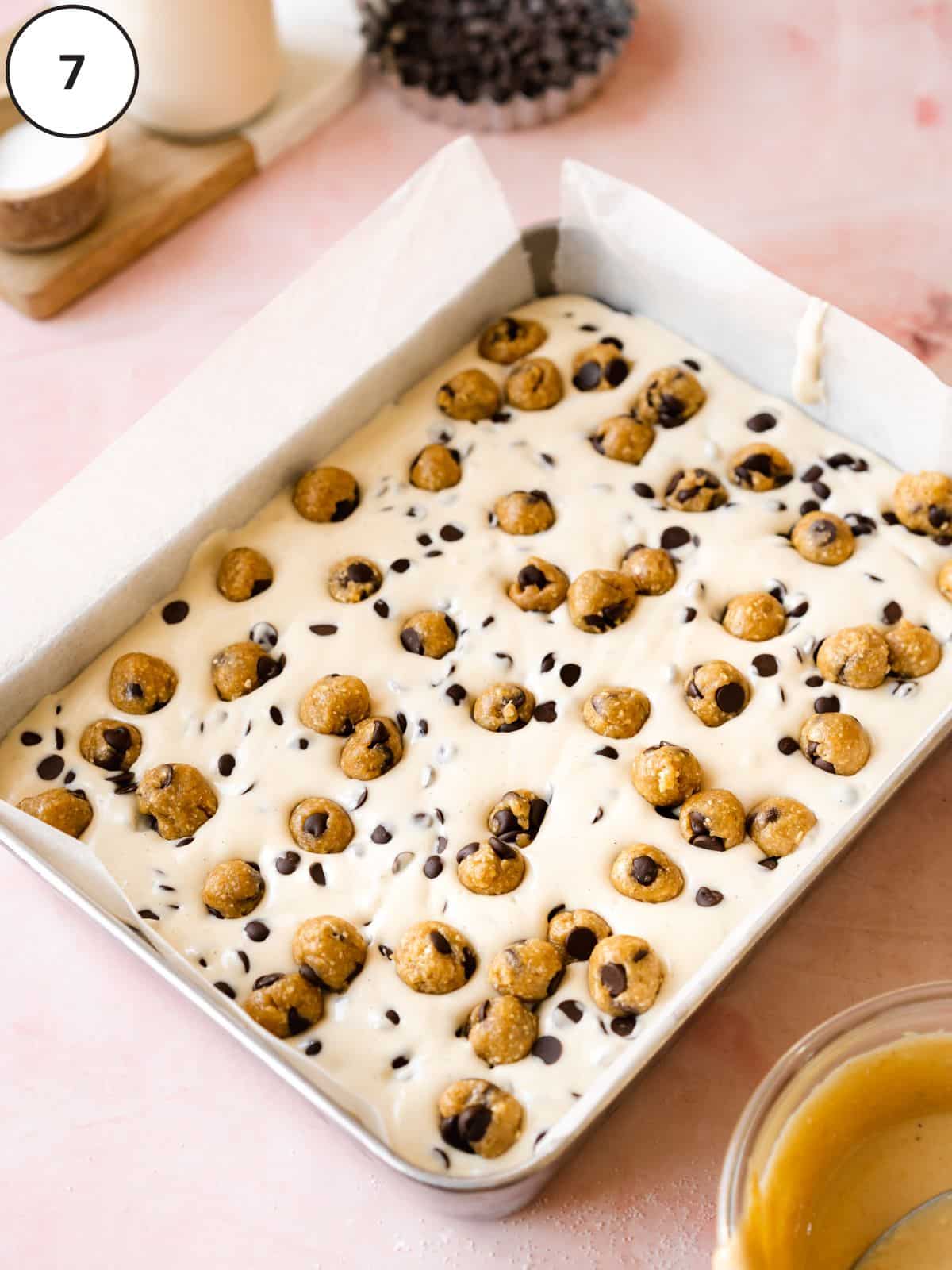 Cookie dough balls added to the top of the cheesecake bars before refrigerating.