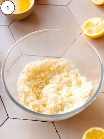 sugar in a bowl with freshly grated lemon zest and vanilla bean rubbed into it.