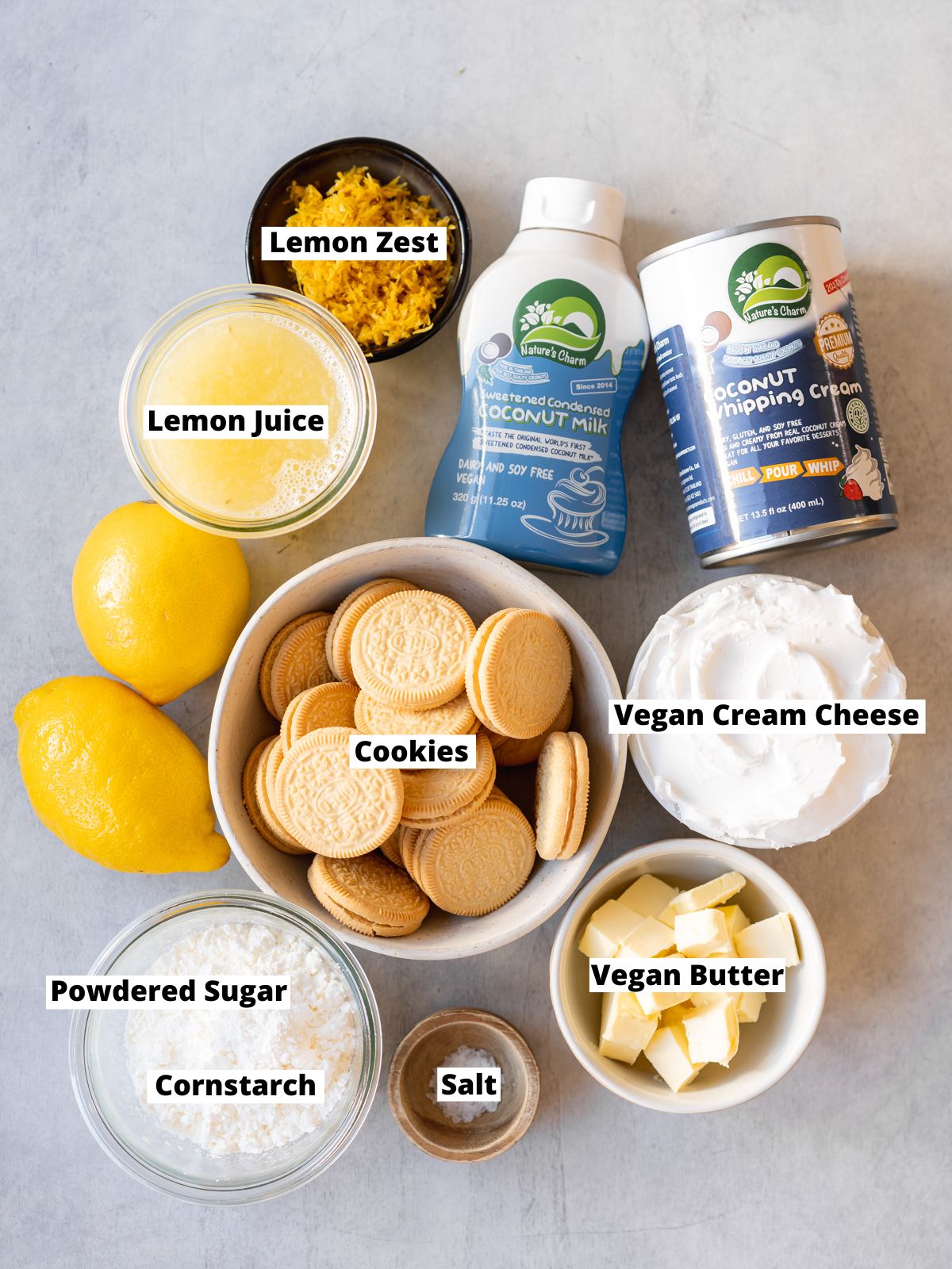Ingredients needed to make lemon lush dessert measured out into bowls on a grey table.