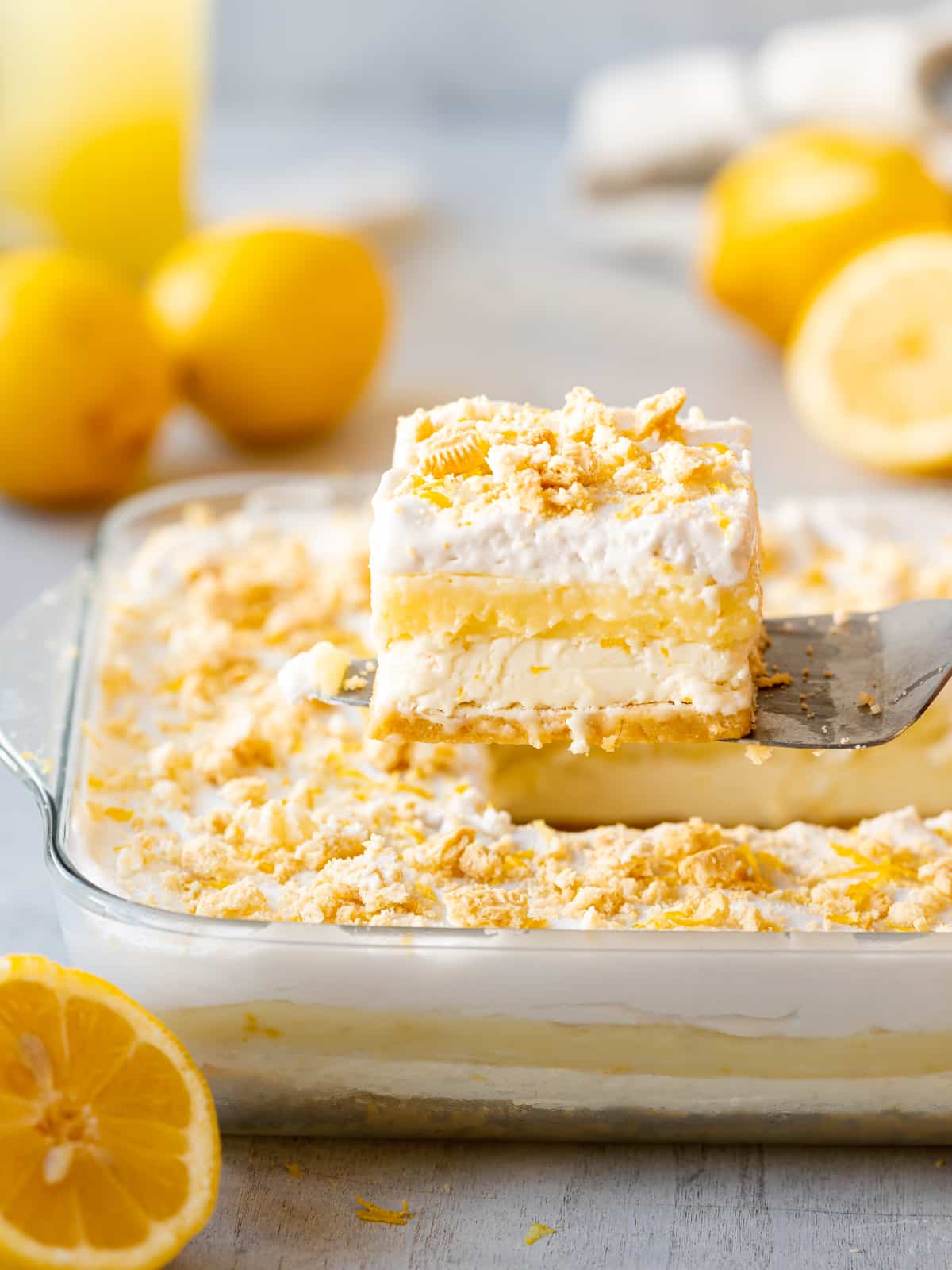 Slice of lemon lasagna being removed from the pan with a cake server.