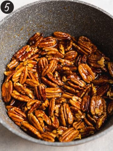 toasted pecans in a saucepan.