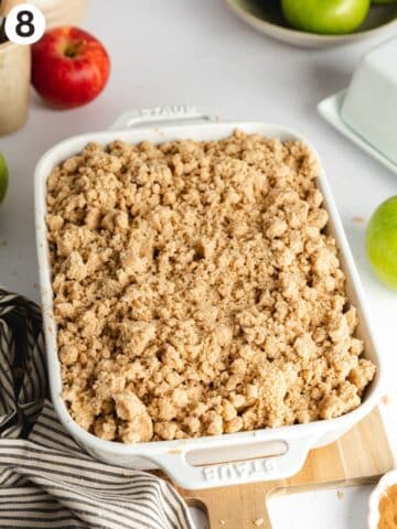 apple crumble in a Staub ceramic dish before baking.