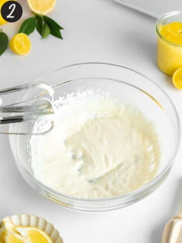 vegan yogurt and cream cheese whipped until fluffy in a bowl with an electric mixer.