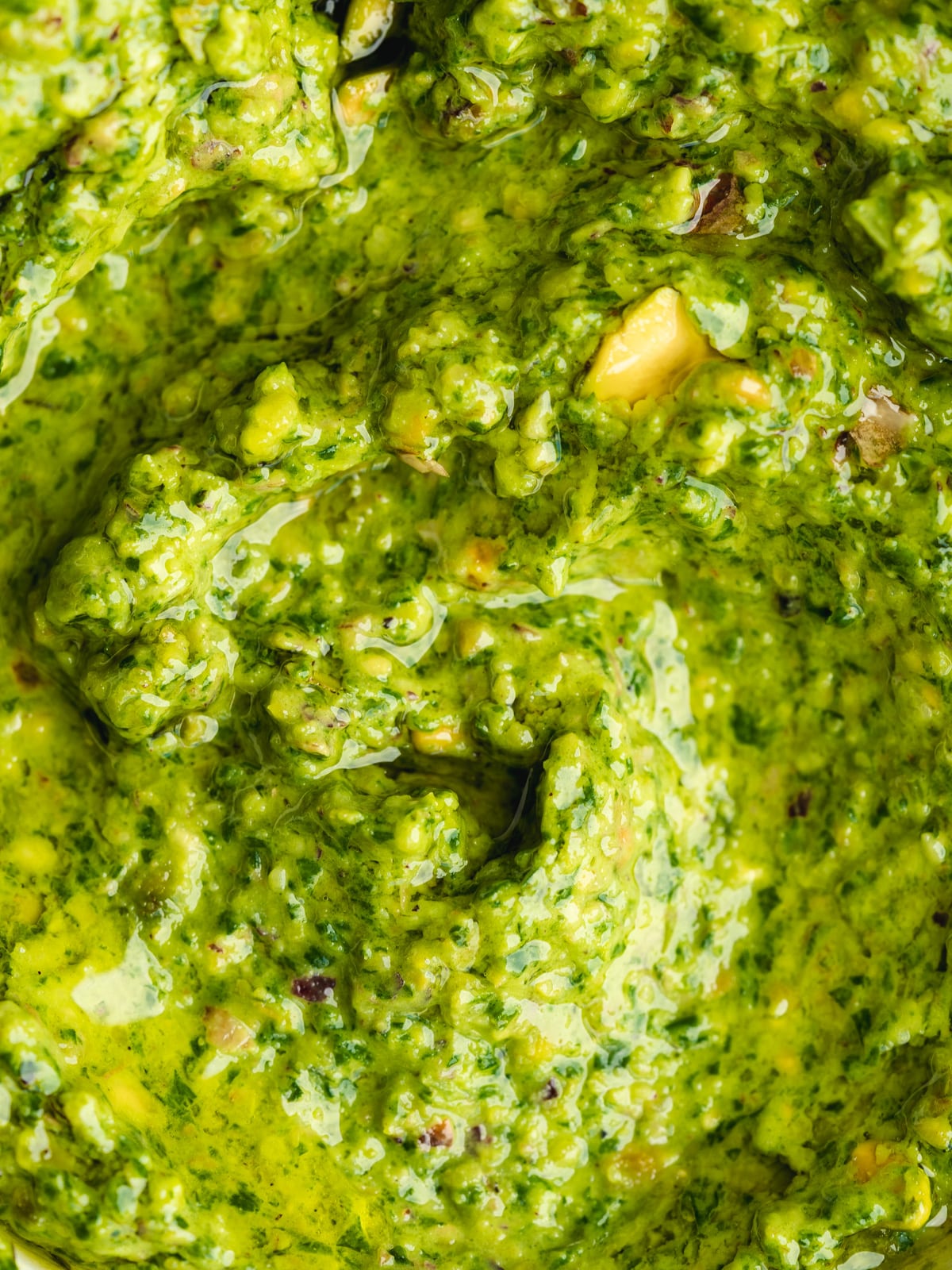 closeup of pistachio basil pesto showing the vibrant green color.