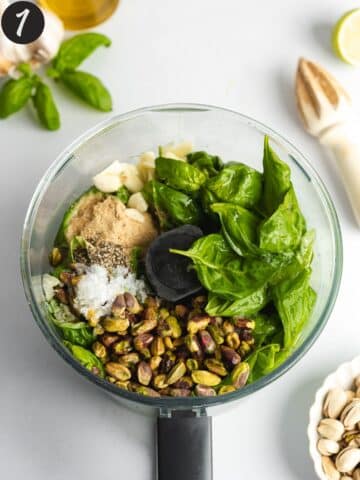 ingredients for pistachio pesto in a food processor jug before blending.
