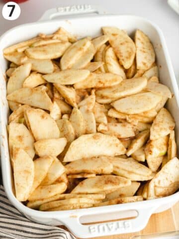 a Staub ceramic dish filled with cinnamon infused apple slices.