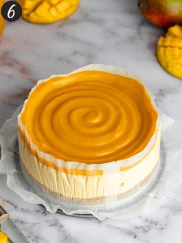 mango cheesecake with mango curd swirl topping just after being taken out of the cake tin.