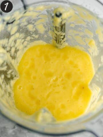 fresh pineapple blended in the jug of a high-speed blender.