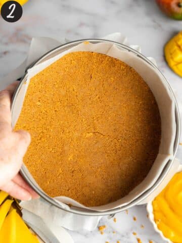 a cake tin with a ginger cookie base pressed into the bottom.