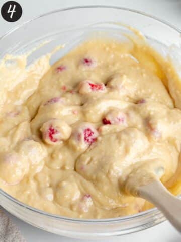 muffin batter with fresh raspberries folded throughout.