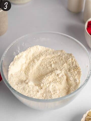 a bowl with all purpose flour, almond flour, baking powder, baking soda, and salt.