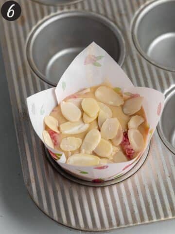 raspberry muffins topped with sliced almonds before going into the oven.