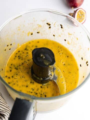passionfruit puree in a food processor with the seeds starting to separate from the juice.