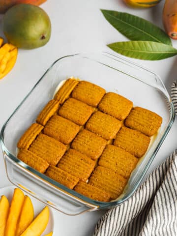 second layer of soaked cookies lined in a glass dish.