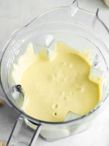 creamy pistachio cheesecake filling in a blender jug.