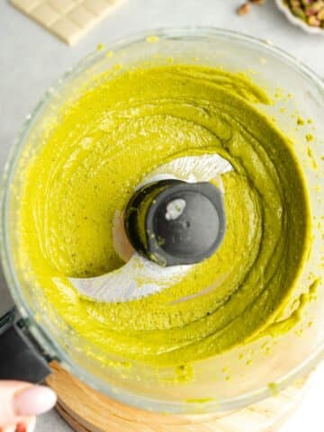 pistachios blended to a smooth paste in a food processor jug.
