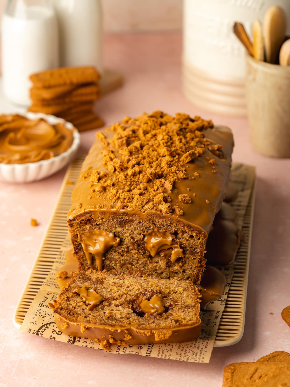 biscoff banana bread with a slice cut away showing the goeey cookie butter dollops inside.