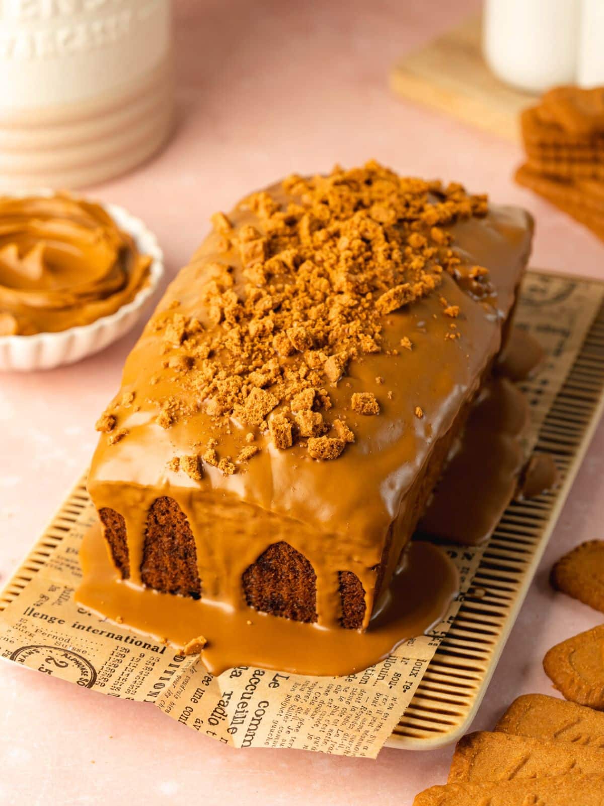 banana bread with biscoff spread poured over the top and some crushed cookies.