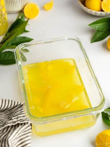 lemon and limoncello syrup in a glass lunch box.