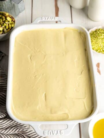 pistachio tiramisu in a ceramic staub dish before going into the fridge to set.