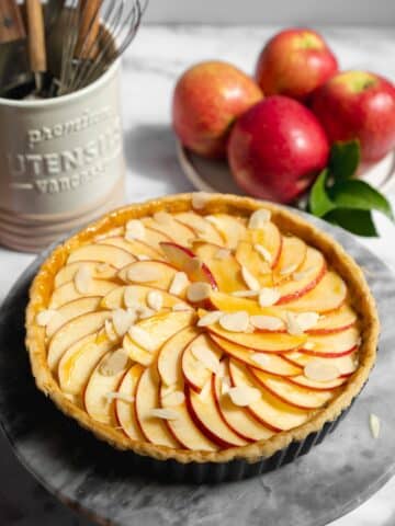 apple tart glazed with apricot jam and sliced apples before baking.