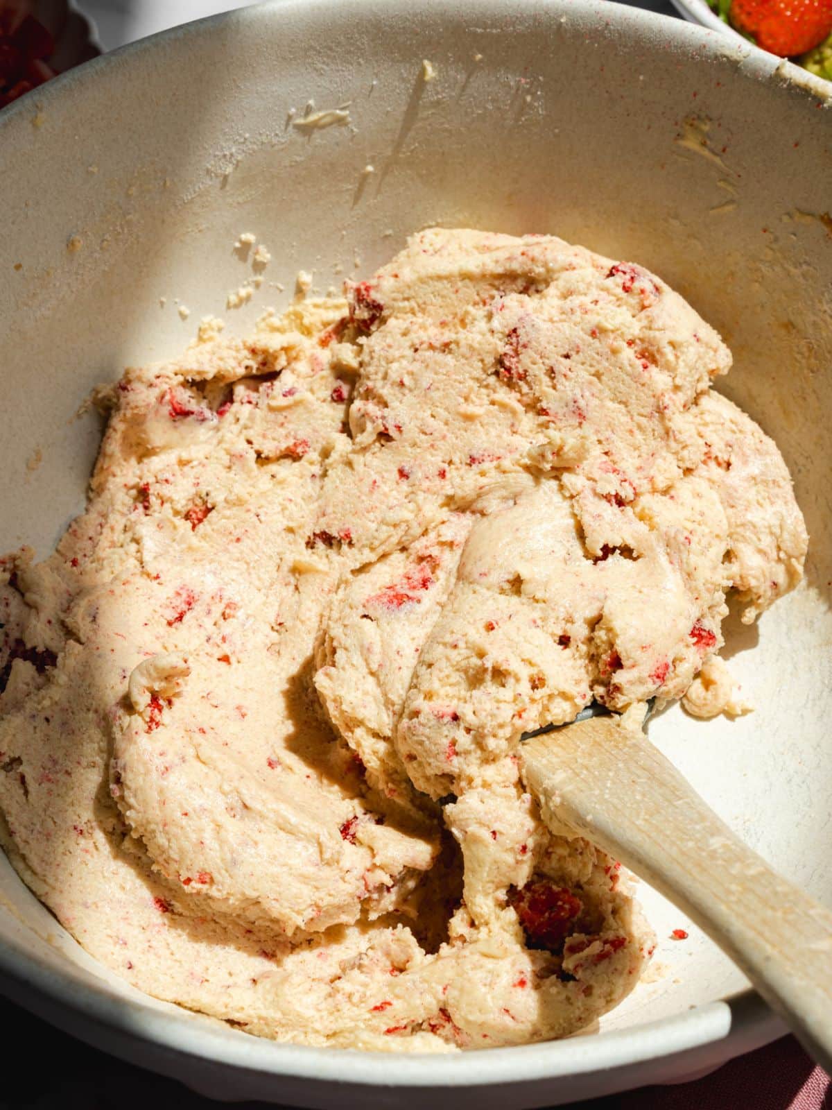 cookie dough with freeze-dried berries in a large mixing bowl.