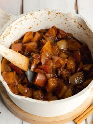 chopped apples, spices, apple cider, and vanilla cooked until soft and sticky in a saucepan.