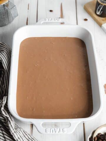 a layer of nutella mascarpone in a staub baking dish.