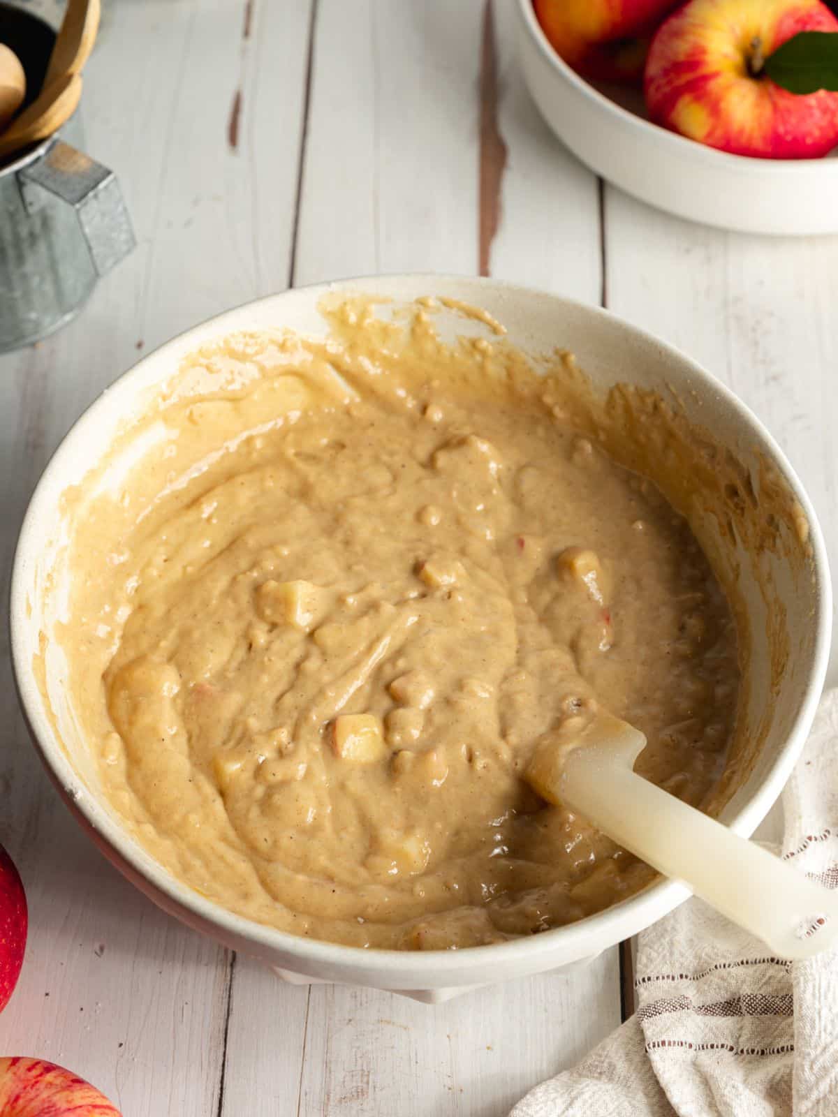 apple muffin batter in a bowl with a spatula.