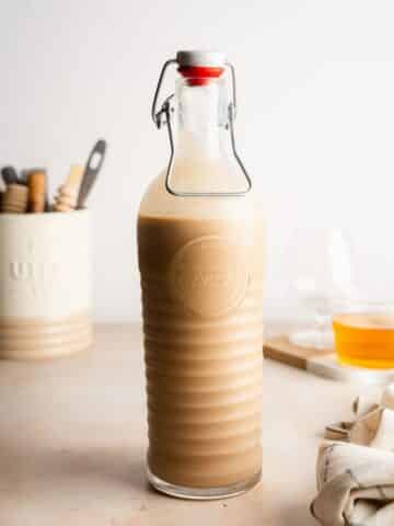 baileys in a tall glass bottle.