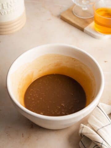 sweetened condensed milk, chocolate syrup, vanilla, and espresso whisked in a bowl.