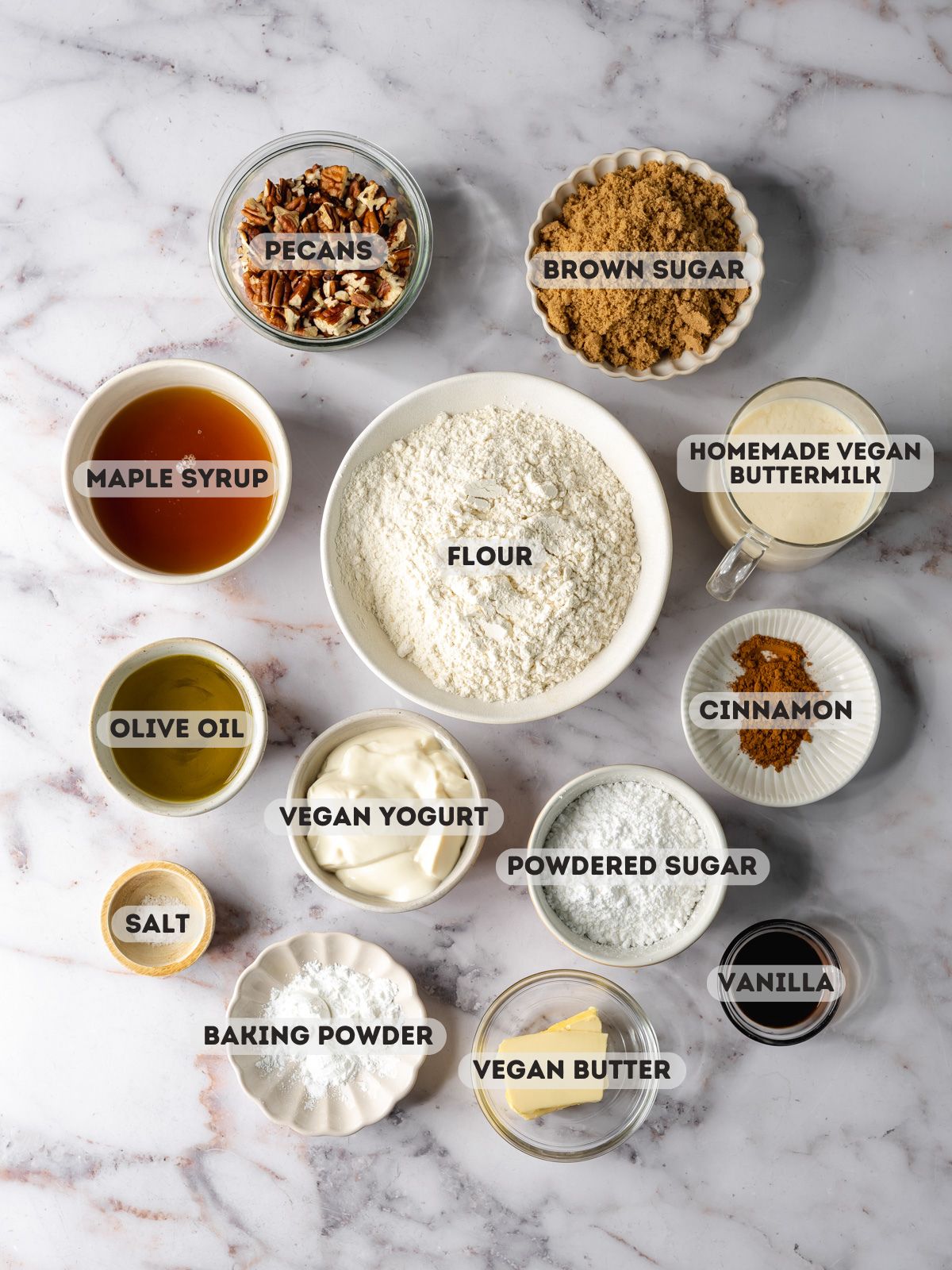 ingredients to make vegan pecan bread measured out in bowls on a marble surface.
