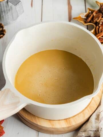 cornstarch and maple syrup whisked into a paste in a white saucepan.