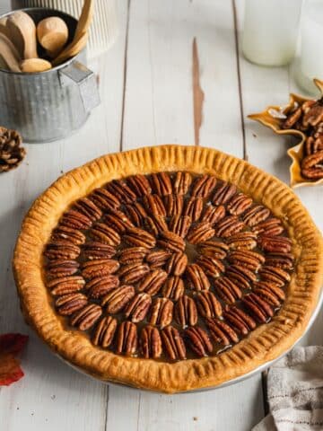 a pecan pie topped with pecan halves before baking.